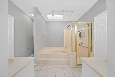 a bathroom with a tub a sink and a shower