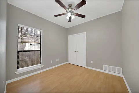 an empty room with chandelier fan