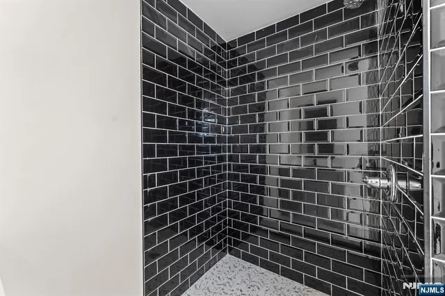 a bathroom with a bathtub shower sink mirror and toilet