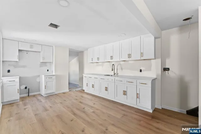 a kitchen with white cabinets and white appliances