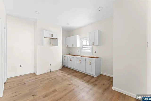 a view of a kitchen with wooden floor