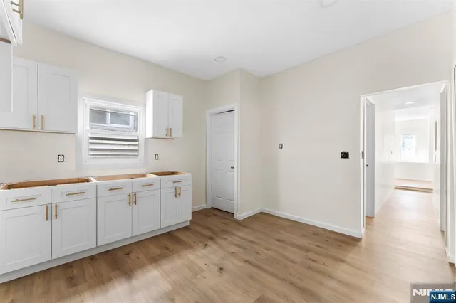 a large white kitchen with a sink