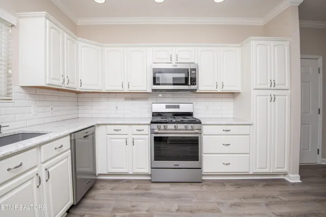 a bathroom with a granite countertop toilet sink and mirror