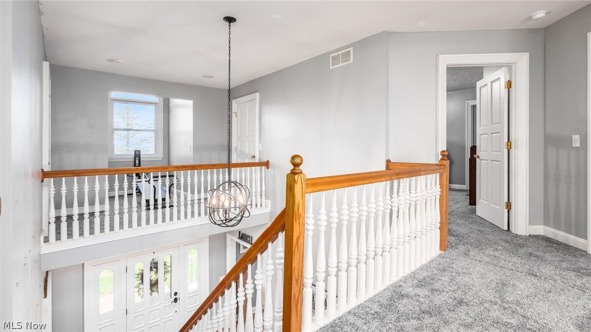 2531 Nicholas Lane Dresden, OH 43821 - Photo 19 of 40 Hall with suspended lighting, an upstairs landing, and carpet flooring