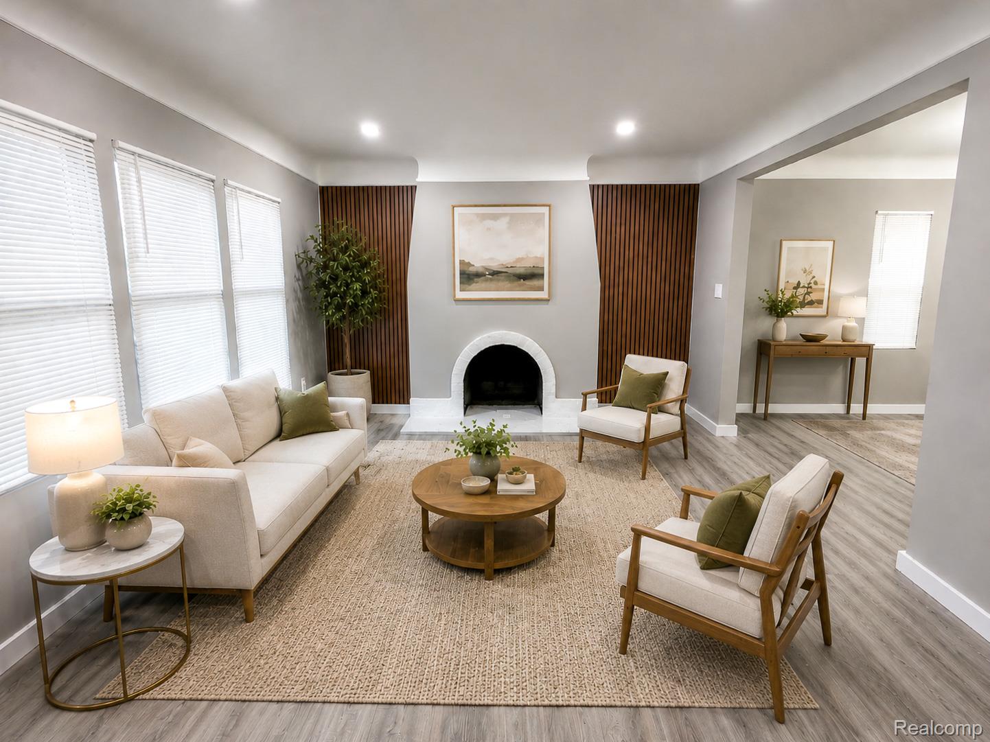 18217 Prairie Street Detroit, MI 48221 - Photo 2 of 34 Virtually staged living room featuring wood-finish flooring, a decorative fireplace with a curved mantel, recessed lighting, and a prominent wood slat accent wall