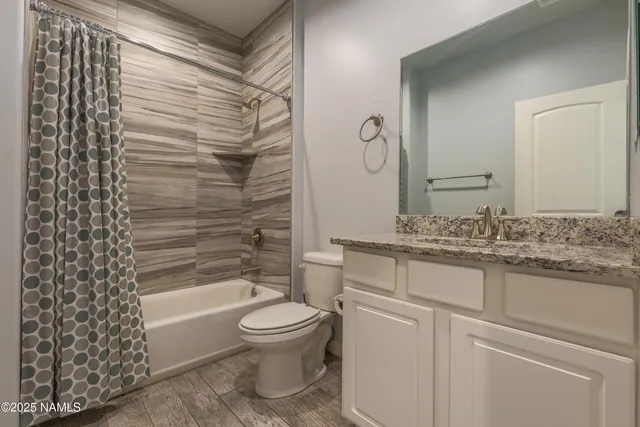 a bedroom with a bed and a chandelier fan