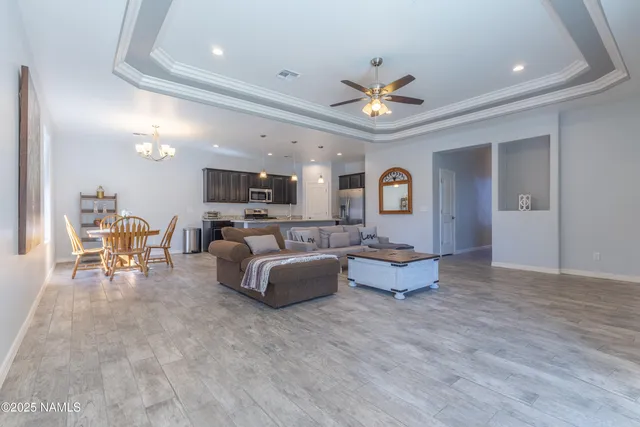 a kitchen with stainless steel appliances granite countertop a sink refrigerator and cabinets