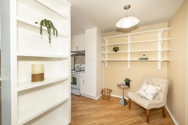 a view of a bedroom with wooden floor and cabinet