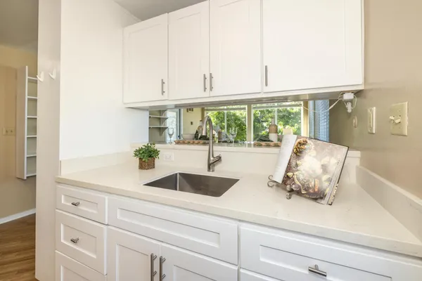 a kitchen with stainless steel appliances white cabinets and a sink
