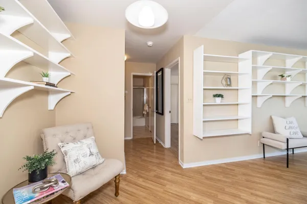 a living room with furniture and a wooden floor