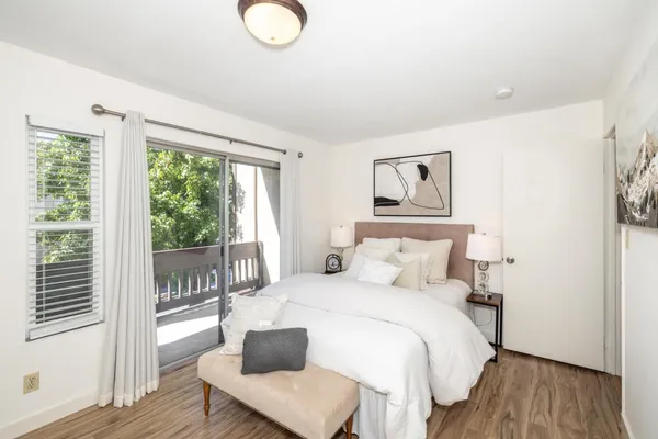 a bedroom with a bed and a large window