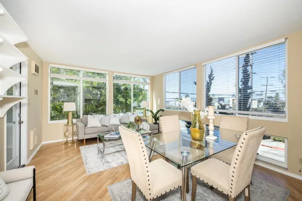 a view of a dining room with furniture window and wooden floor