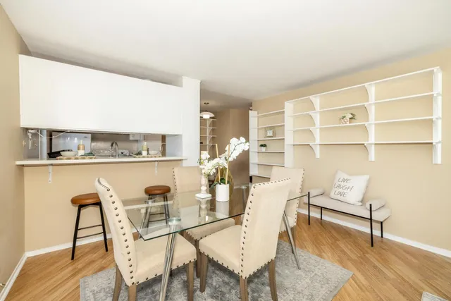 a dining room with furniture and wooden floor