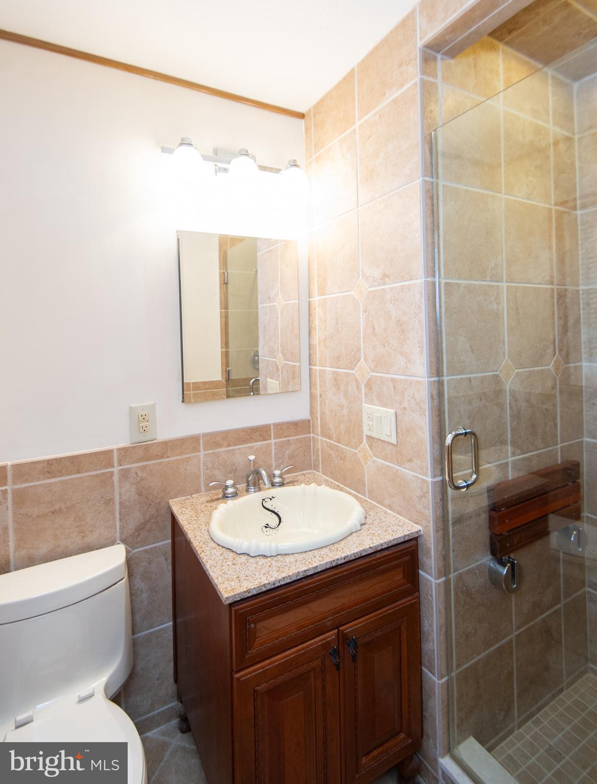 2 Algonquin Road Cambridge, MD 21613 - Photo 14 of 26 a bathroom with a sink toilet and shower