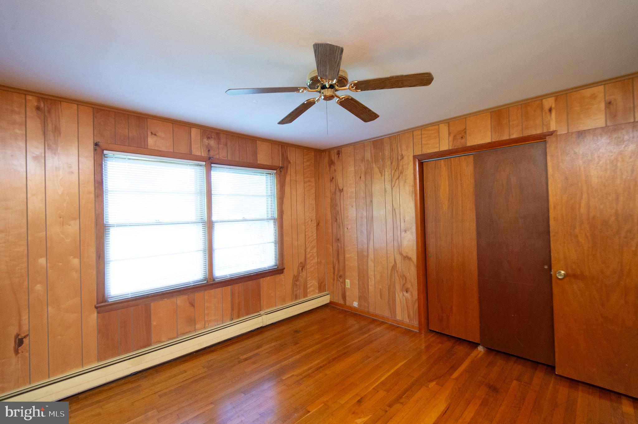 2 Algonquin Road Cambridge, MD 21613 - Photo 16 of 26 an empty room with wooden floor fan and windows