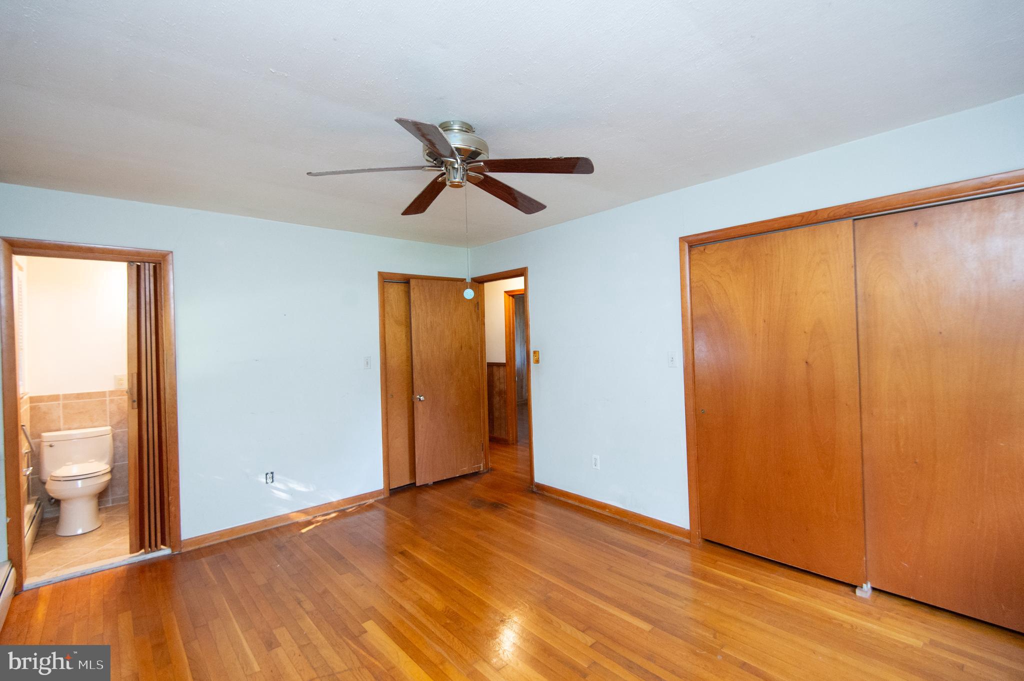 2 Algonquin Road Cambridge, MD 21613 - Photo 19 of 26 a view of empty room with wooden floor and fan