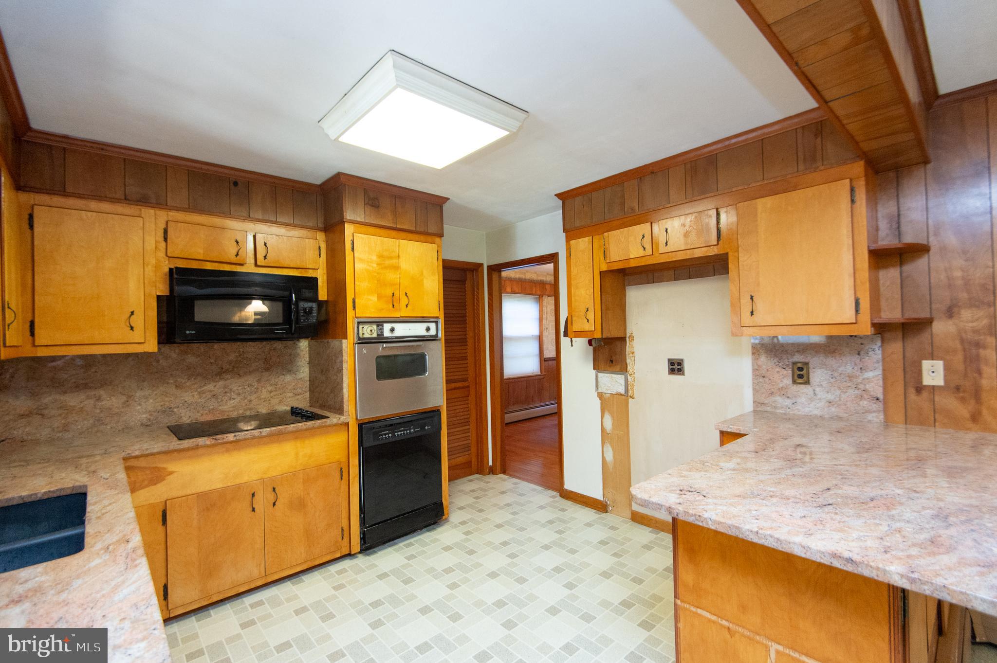 2 Algonquin Road Cambridge, MD 21613 - Photo 9 of 26 a kitchen with stainless steel appliances granite countertop a sink and a refrigerator