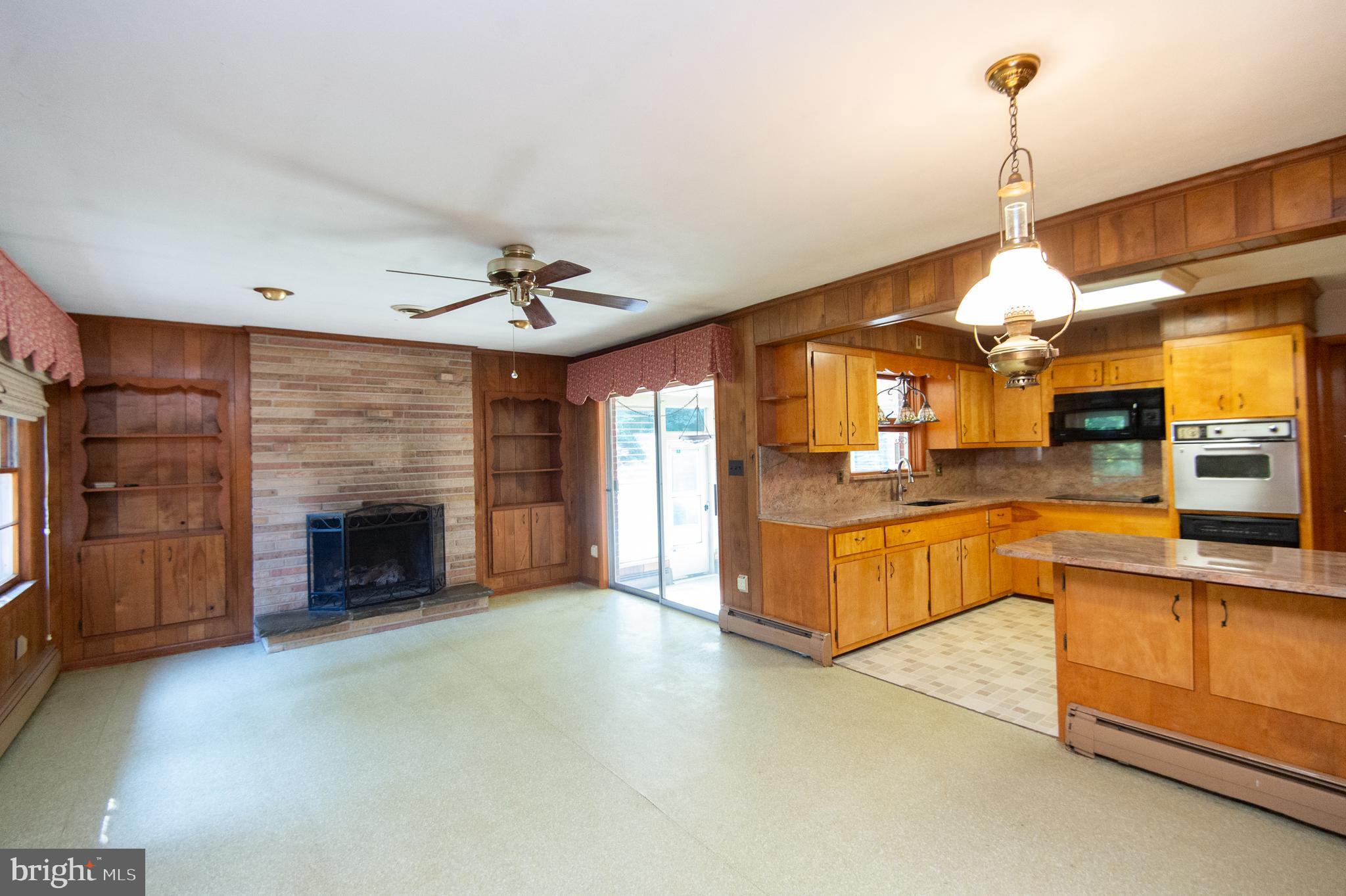 2 Algonquin Road Cambridge, MD 21613 - Photo 10 of 26 a large kitchen with a stove and a fireplace