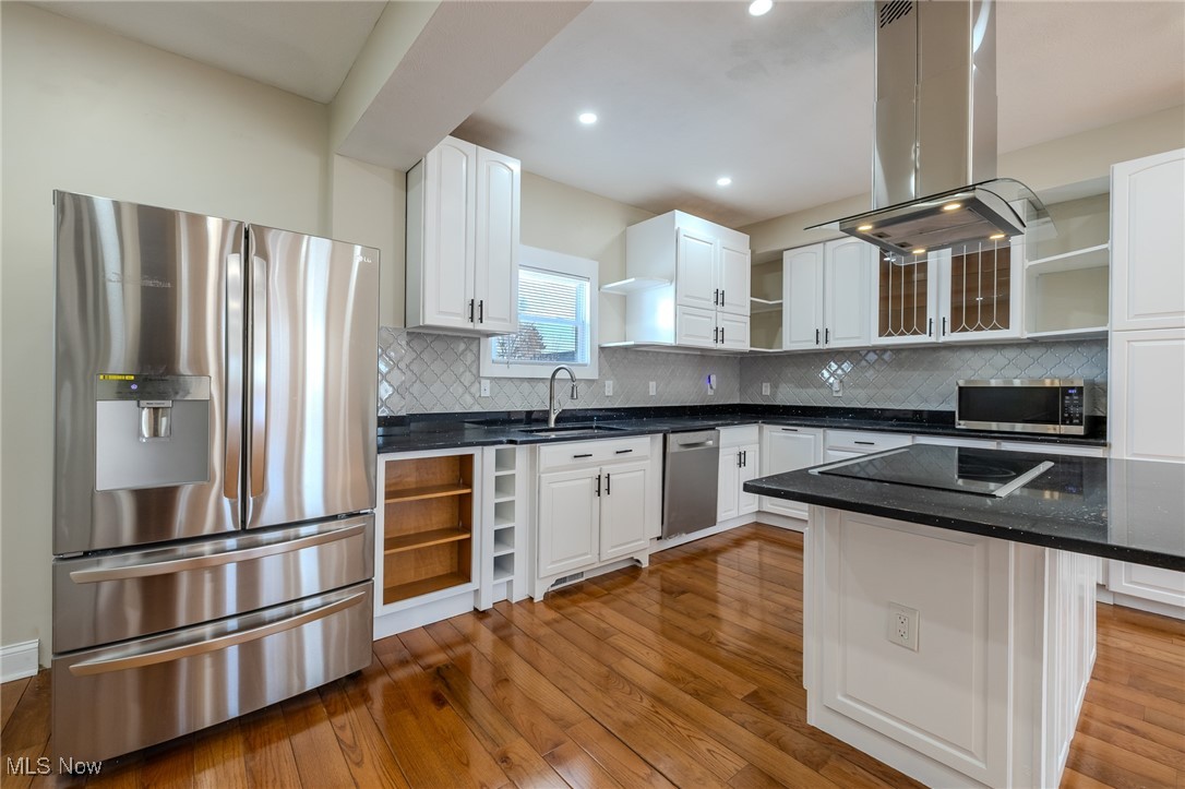 3516 Broadview Road Cleveland, OH 44109 - Photo 15 of 42 Kitchen with open shelves, island exhaust hood, stainless steel appliances, white cabinetry, and a sink