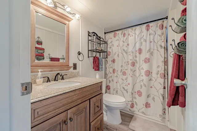 a bathroom with a sink toilet and shower