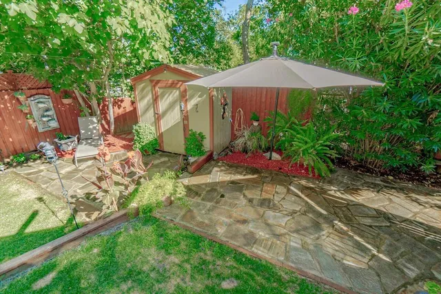 a view of a backyard with under an umbrella