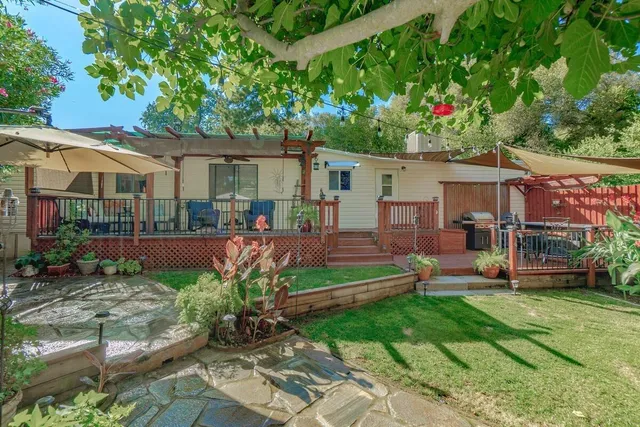 a view of a house with a yard and sitting area