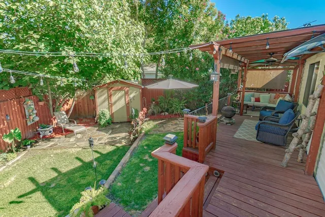 a view of a patio with table and chairs potted plants with wooden floor
