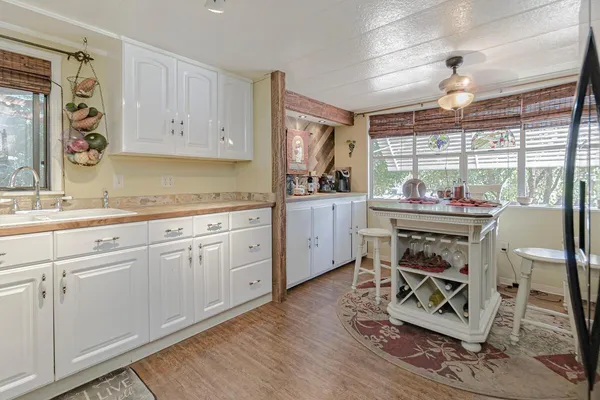 a kitchen with stainless steel appliances a stove a sink cabinets and a window