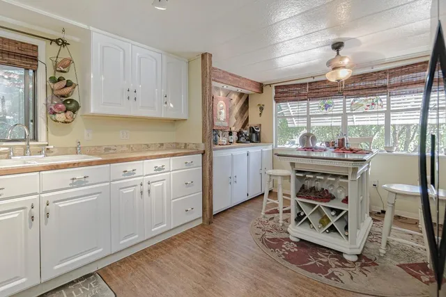 a kitchen with stainless steel appliances a stove a sink cabinets and a window
