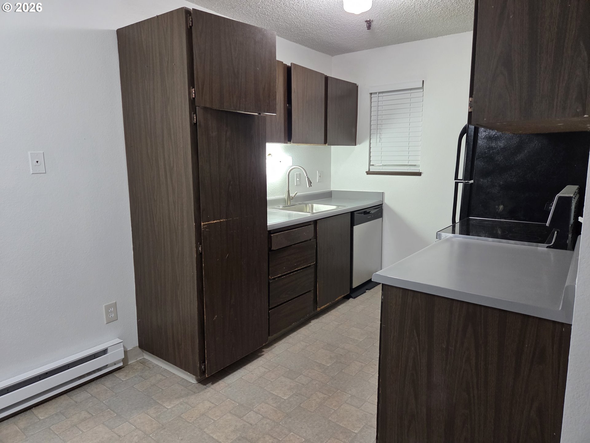 13397 Southwest 17th Street Beaverton, OR 97008 - Photo 21 of 31 a kitchen with stainless steel appliances granite countertop a refrigerator and a sink