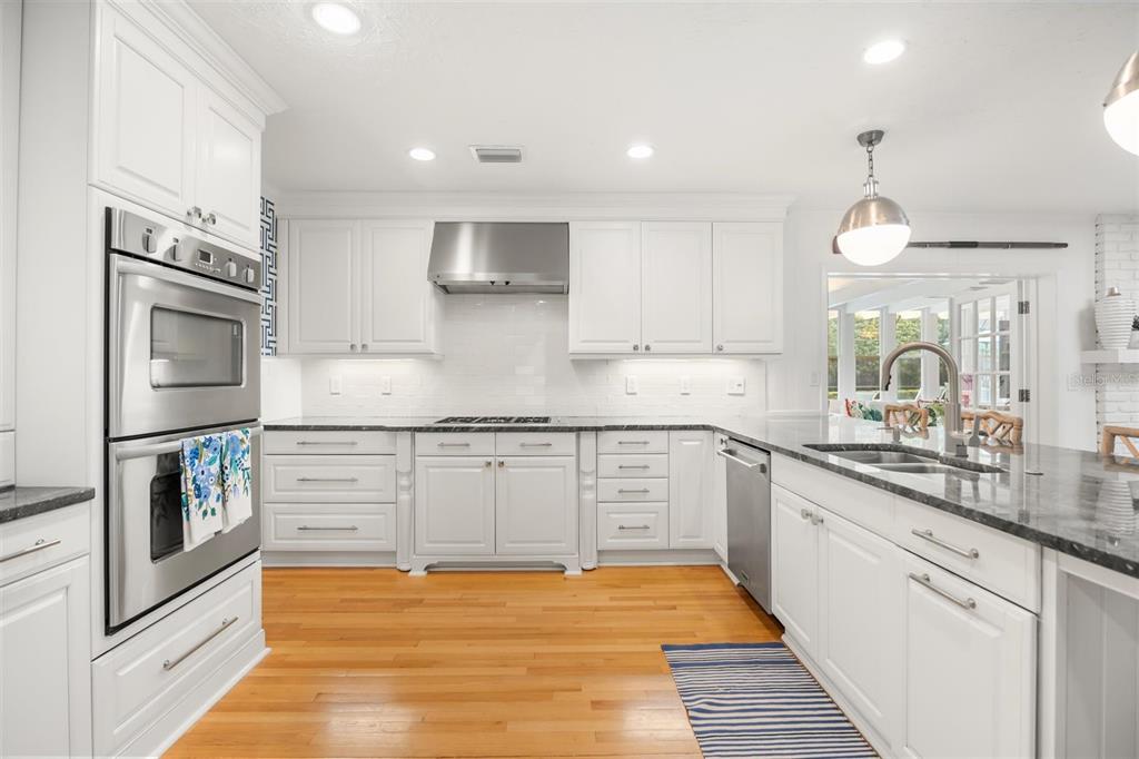 800 Juanita Rael Road Winter Park, FL 32789 - Photo 11 of 36 a kitchen with stainless steel appliances granite countertop a sink stove and refrigerator