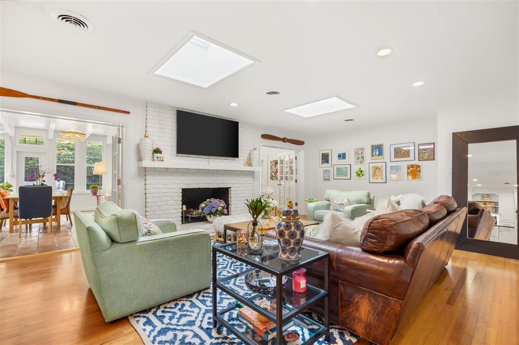 800 Juanita Rael Road Winter Park, FL 32789 - Photo 13 of 36 a living room with furniture a fireplace and a flat screen tv