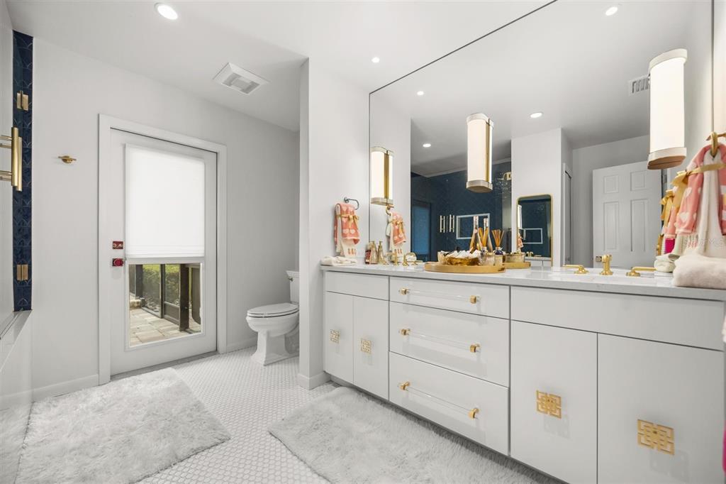 800 Juanita Rael Road Winter Park, FL 32789 - Photo 28 of 36 a spacious bathroom with a granite countertop sink a toilet and a mirror