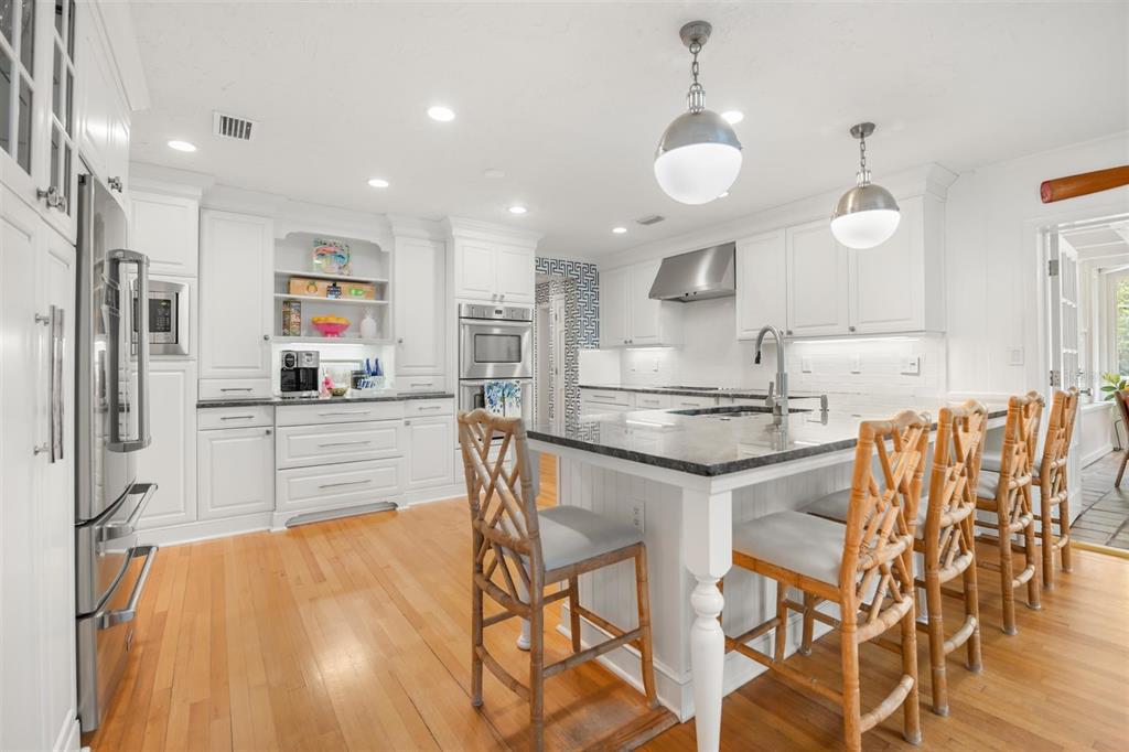 800 Juanita Rael Road Winter Park, FL 32789 - Photo 10 of 36 a kitchen with stainless steel appliances granite countertop a sink and a refrigerator