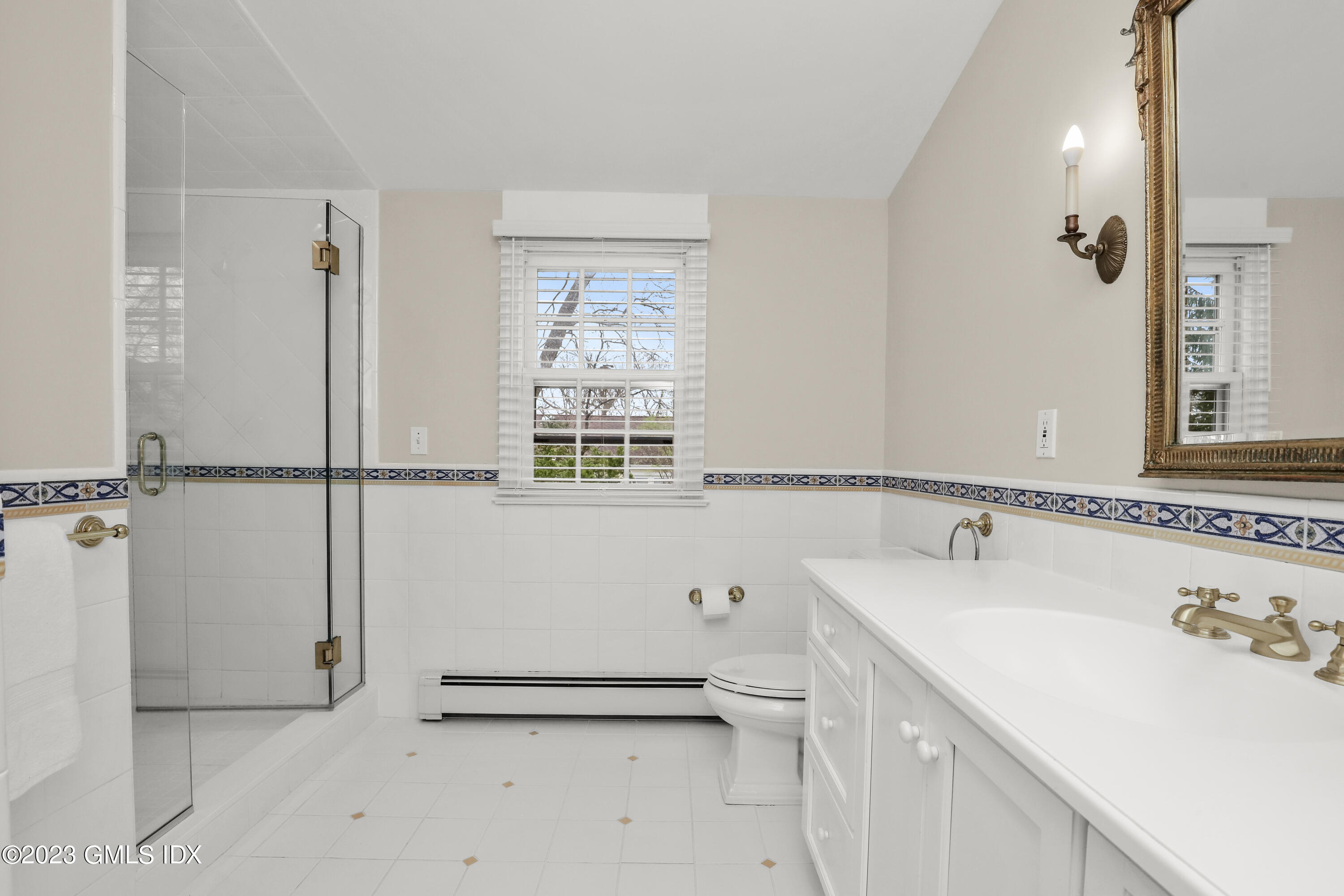 33 Bote Road Greenwich, CT 06830 - Photo 22 of 33 a bathroom with a sink a toilet and shower