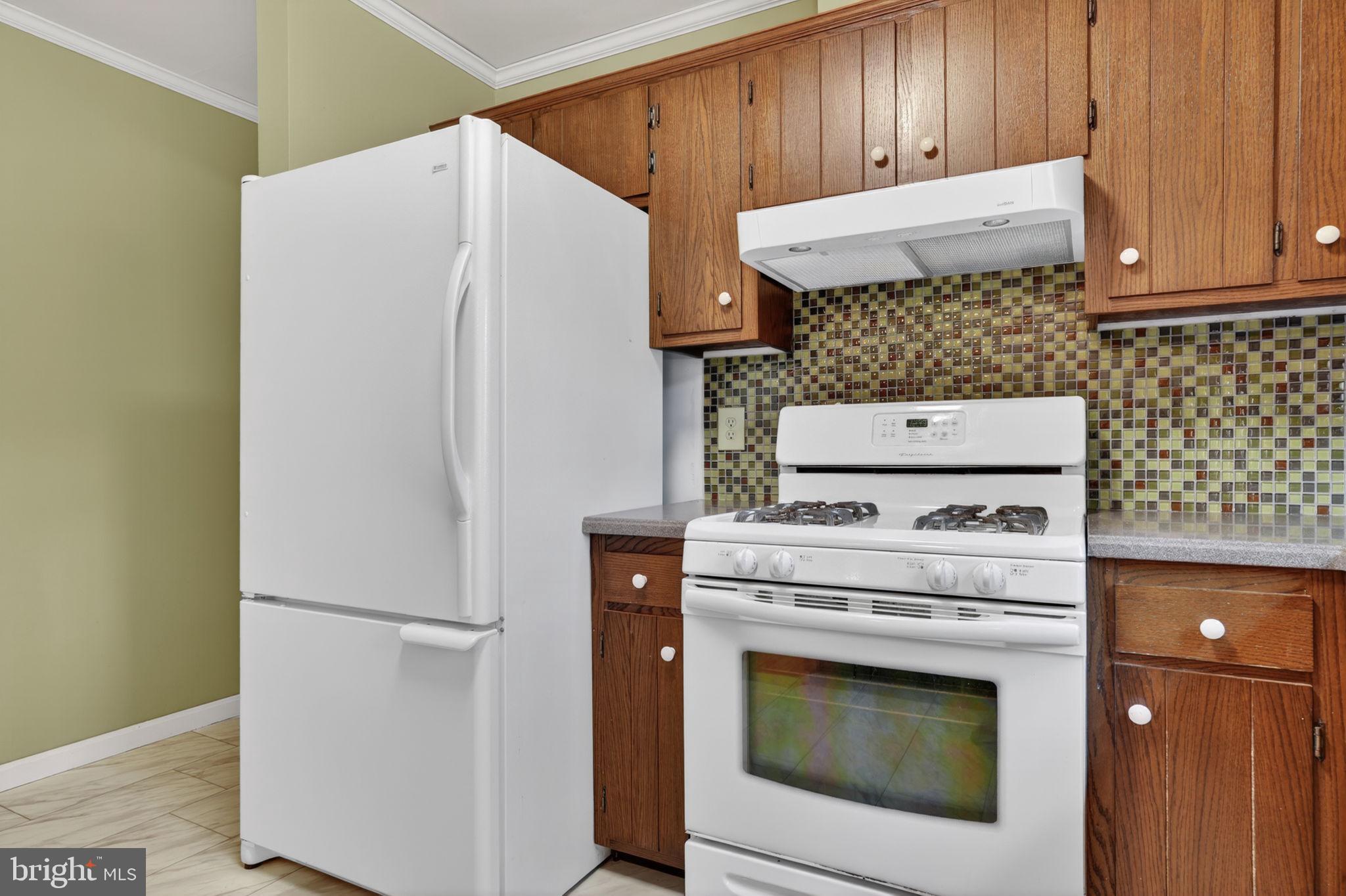 14123 Winterville Road Bloxom, VA 23308 - Photo 14 of 84 a white refrigerator freezer sitting inside of a kitchen
