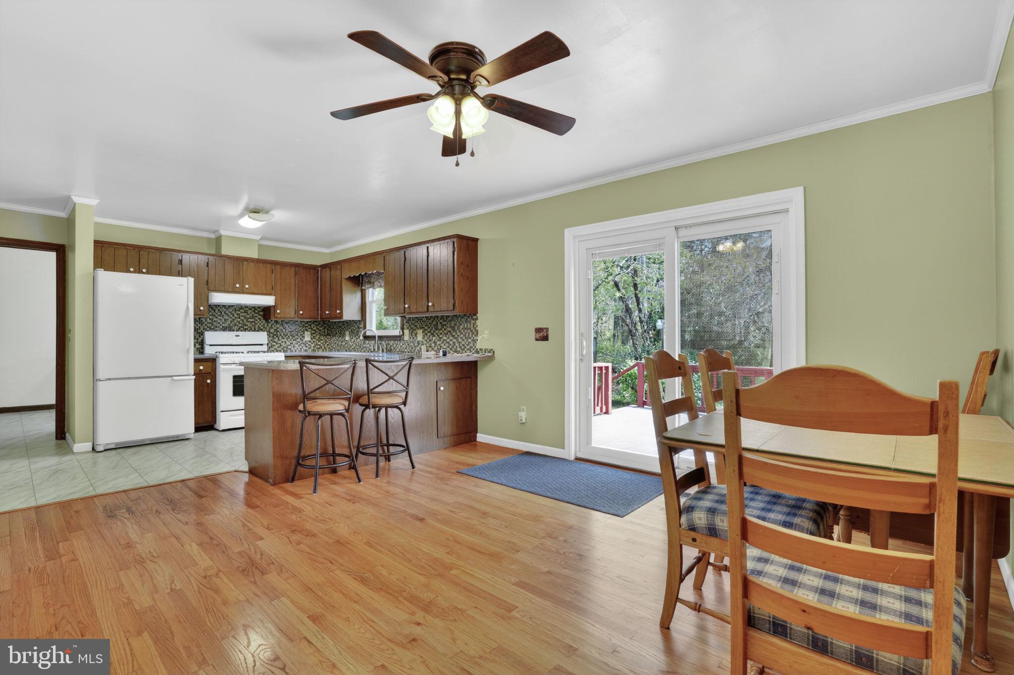 14123 Winterville Road Bloxom, VA 23308 - Photo 17 of 84 a view of a dining room with furniture window and wooden floor