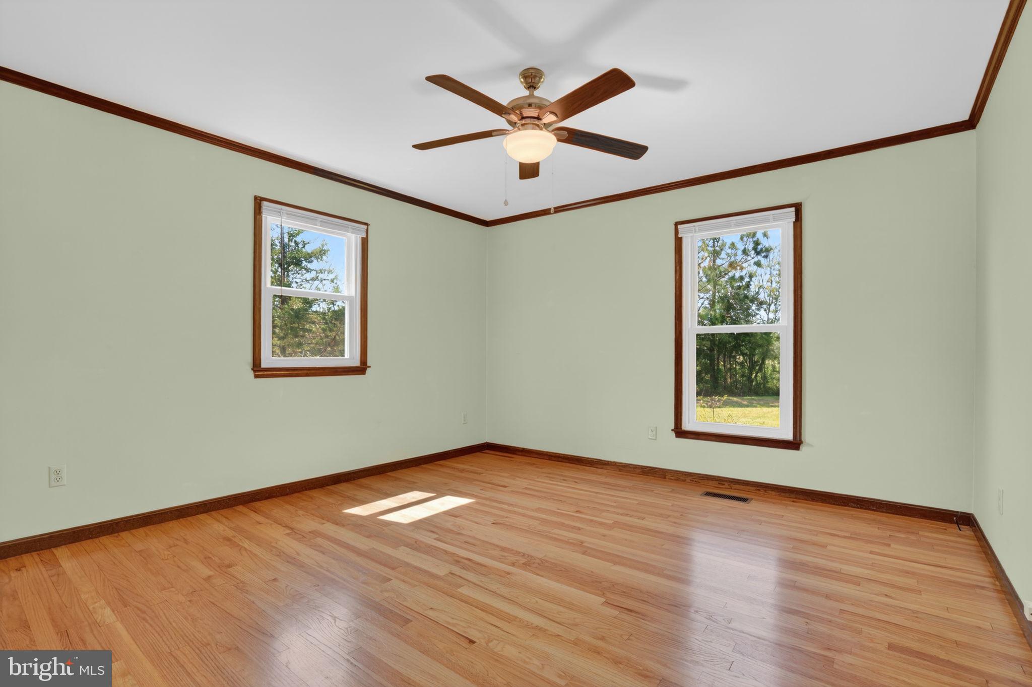 14123 Winterville Road Bloxom, VA 23308 - Photo 20 of 84 a view of empty room with wooden floor and ceiling fan