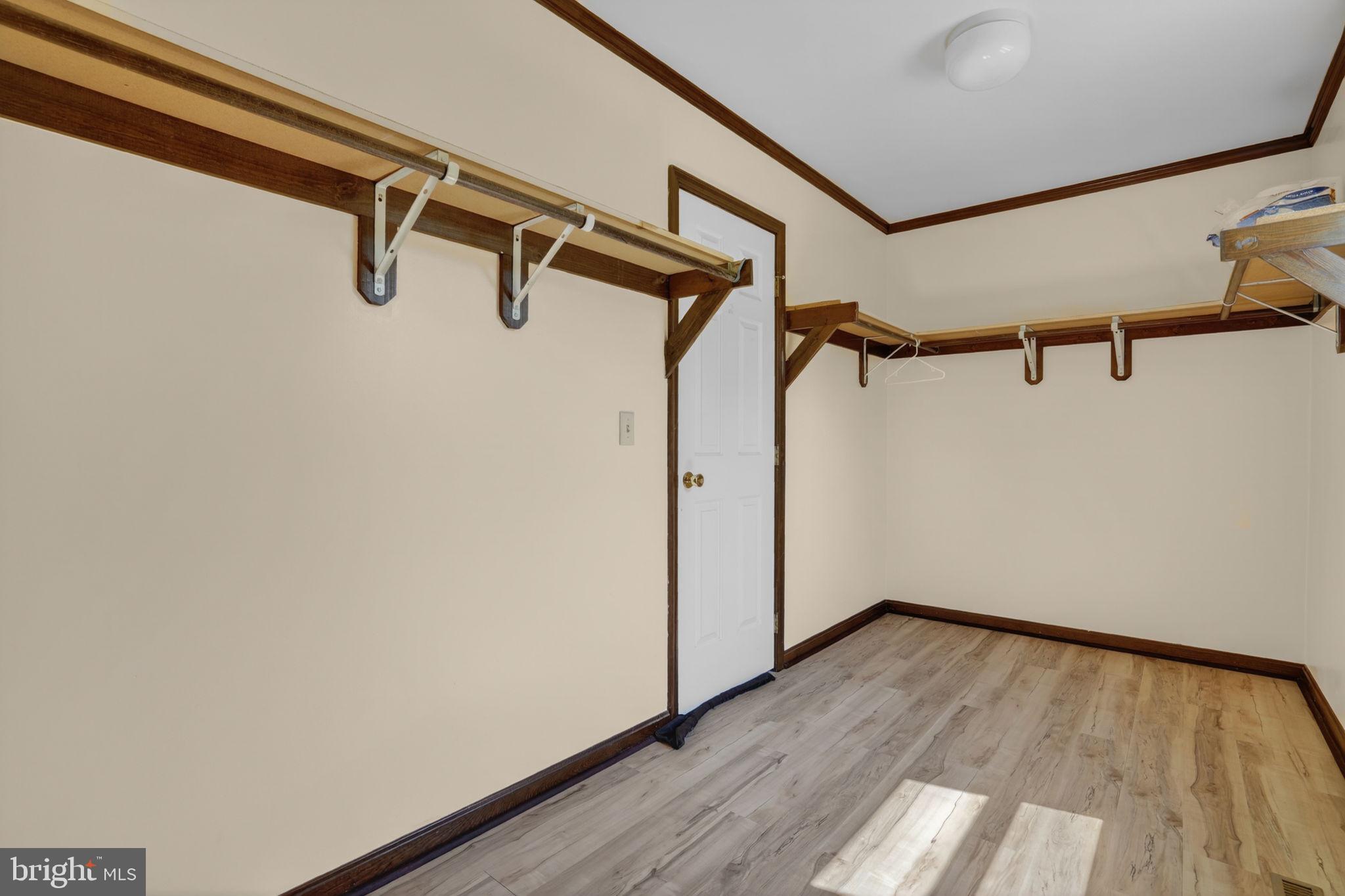 14123 Winterville Road Bloxom, VA 23308 - Photo 22 of 84 a view of walk in closet with empty racks