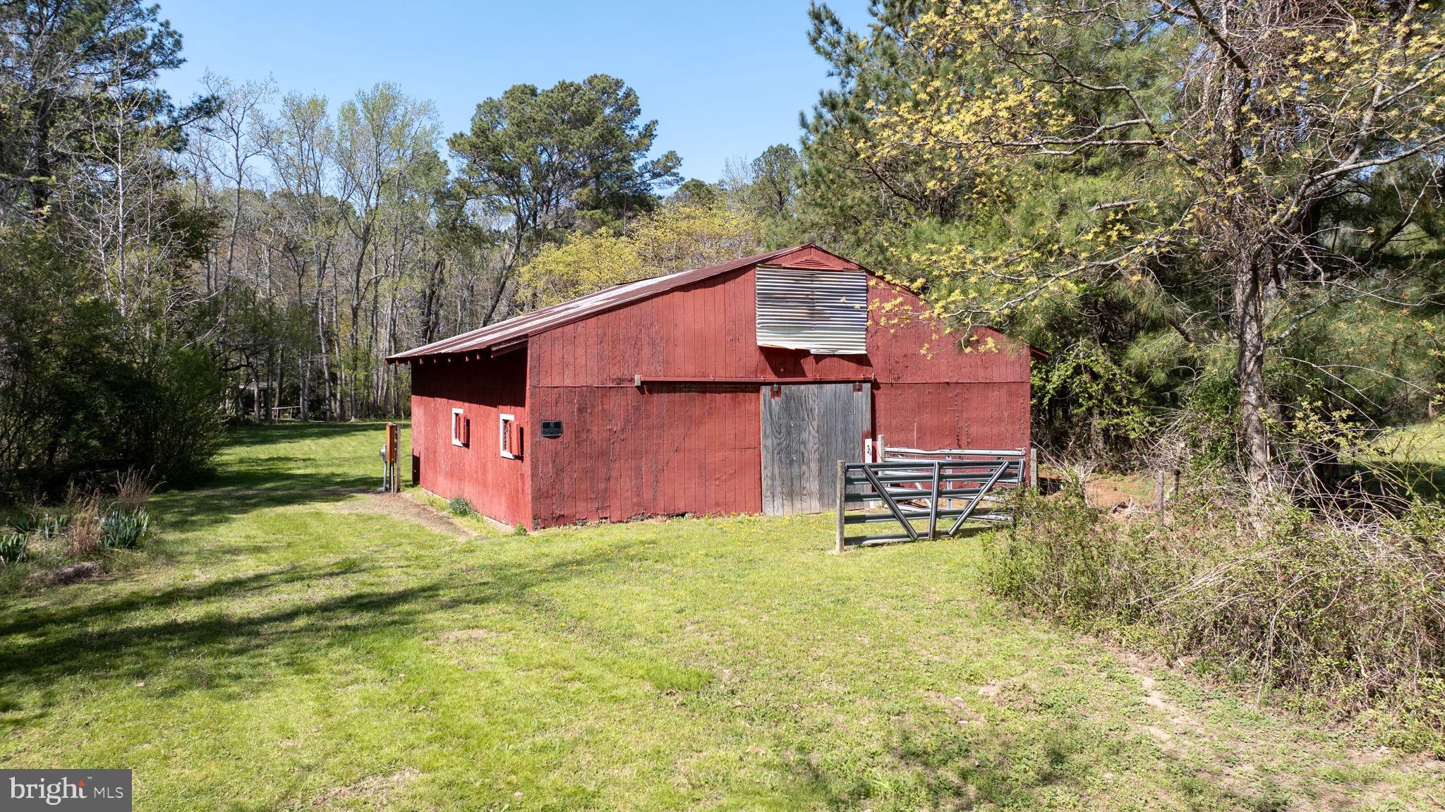 14123 Winterville Road Bloxom, VA 23308 - Photo 80 of 84 a aerial view of a house with table and chairs under an umbrella
