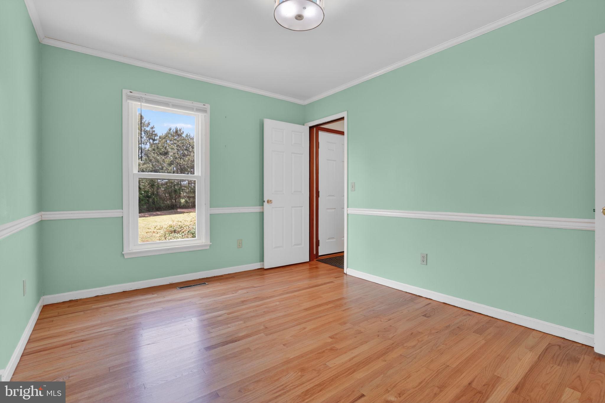 14123 Winterville Road Bloxom, VA 23308 - Photo 8 of 84 a view of a room with wooden floor and windows