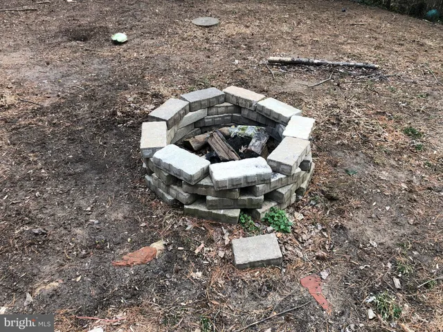 a view of a house with pool next to a large tree