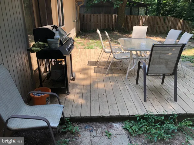 a kitchen with granite countertop a refrigerator and a stove top oven
