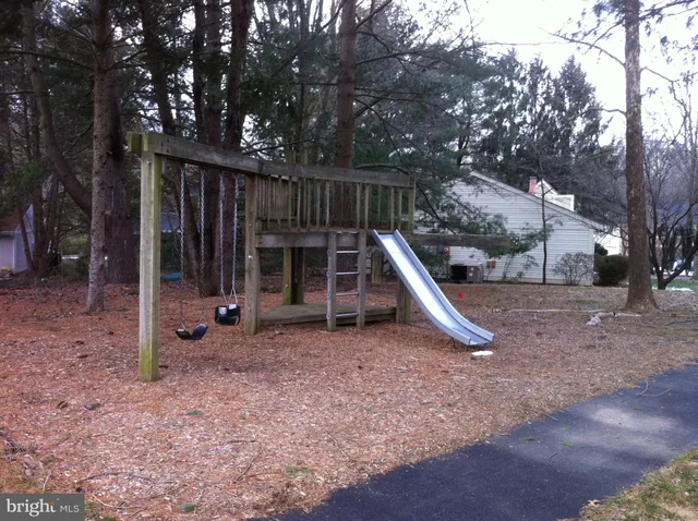 a kitchen with stainless steel appliances a dining table chairs and granite top