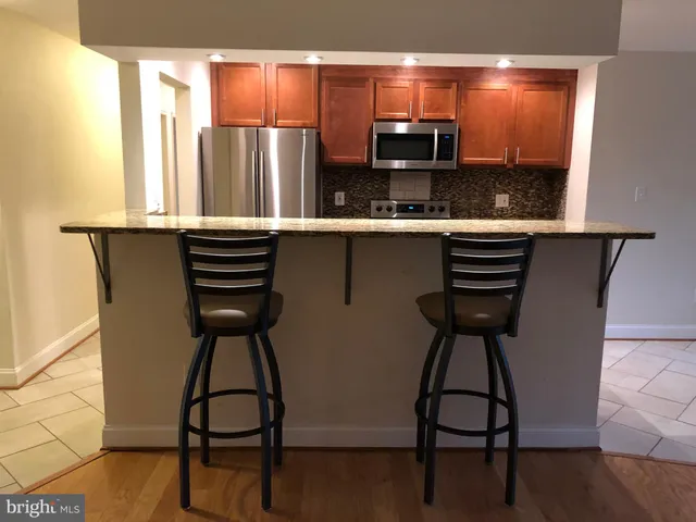 a kitchen with stainless steel appliances a sink and a refrigerator