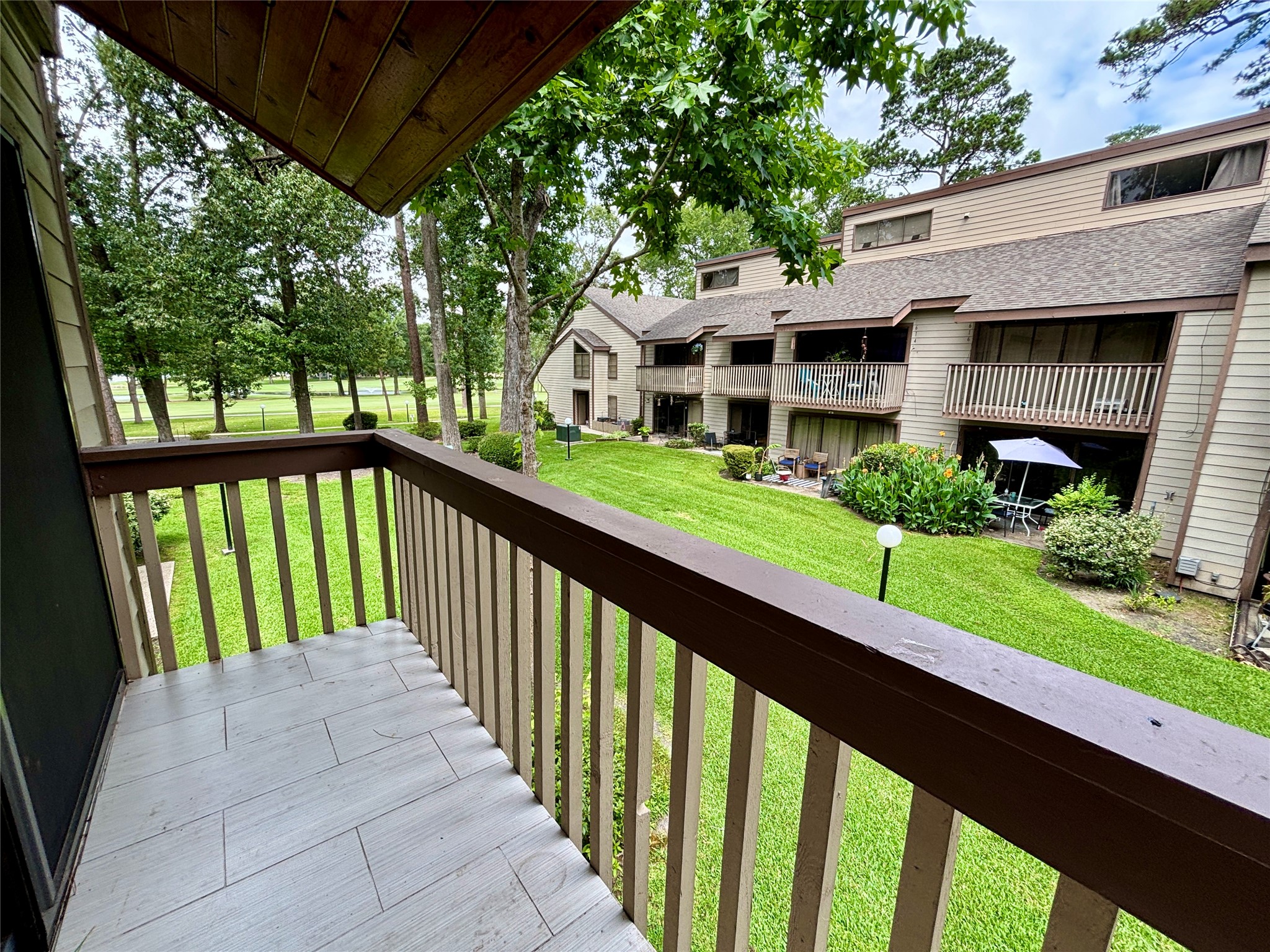 12900 Walden Road, Unit 508E Montgomery, TX 77356 - Photo 18 of 25 a view of a house with a yard and large trees