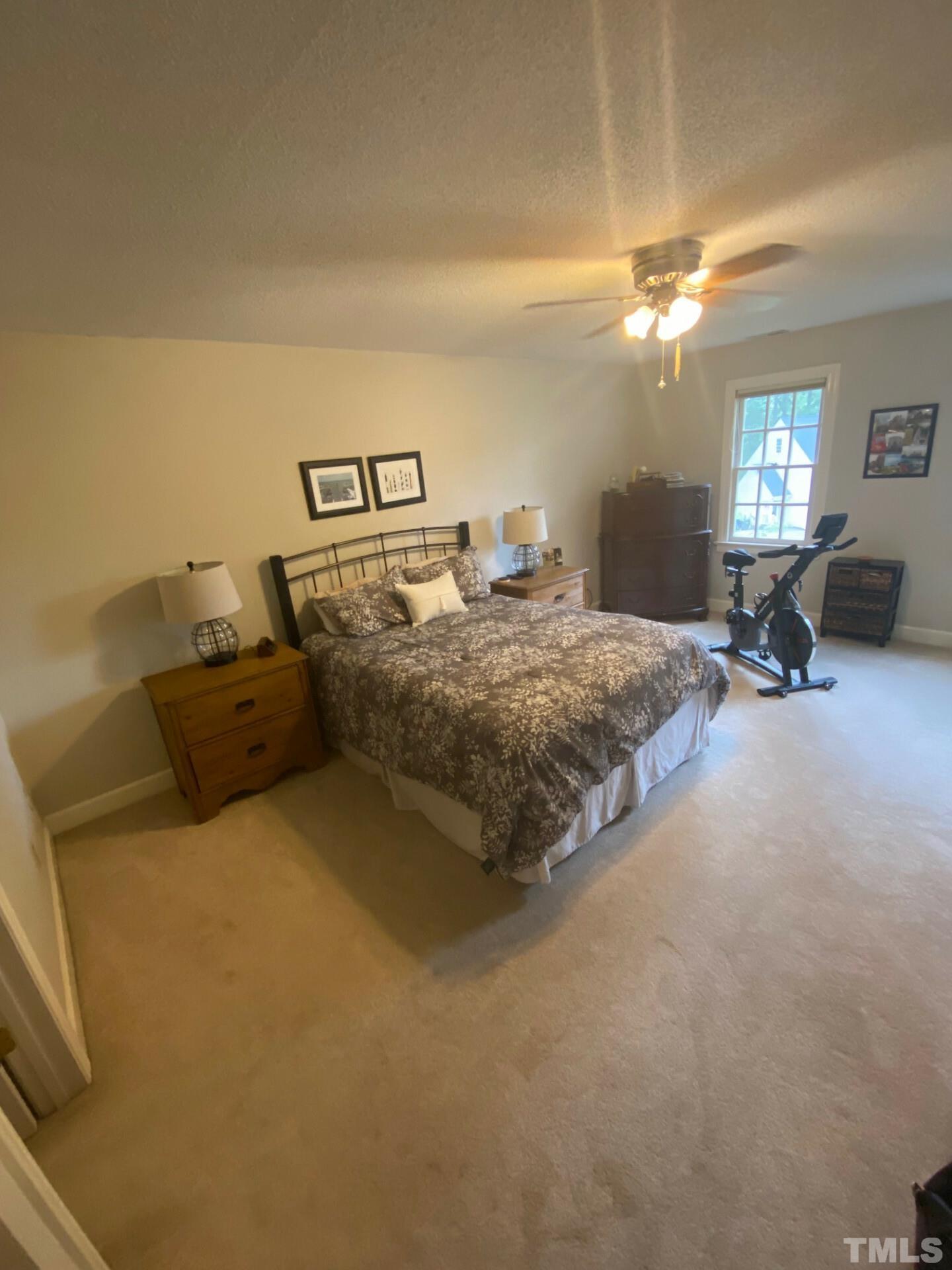 8713 Master Court Raleigh, NC 27615 - Photo 9 of 17 a bed room with a bed and a night stand
