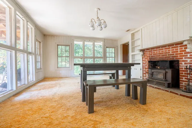 a view of livingroom with furniture fireplace and window