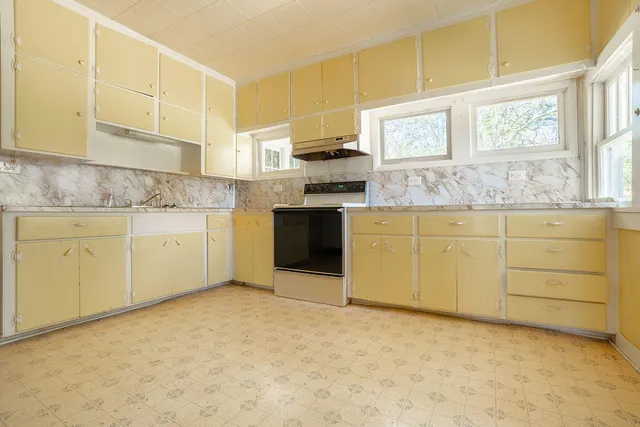 a kitchen with stainless steel appliances granite countertop a stove sink and cabinets