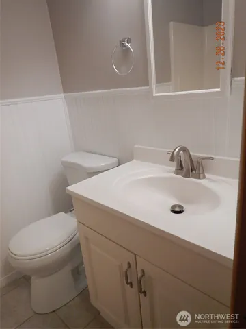 a bathroom with a sink a toilet and mirror